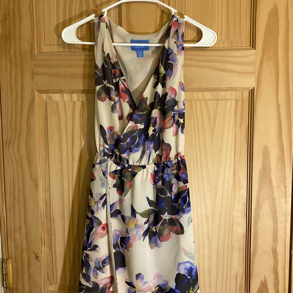 A medium short dress that is silky and has a flower print.